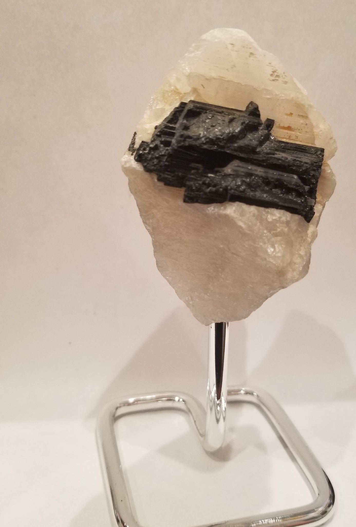 Black tourmaline in quartz on stand